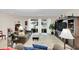 Bright living room featuring tile floors, neutral paint, access to the lanai, and a large TV entertainment center at 1545 Caterpillar St, St Cloud, FL 34771