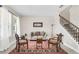 Bright living room with neutral walls, tile flooring, large windows, and staircase at 1545 Caterpillar St, St Cloud, FL 34771
