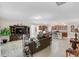 Open-concept living space with tile floors, large windows, comfortable seating, and adjacent kitchen area at 1545 Caterpillar St, St Cloud, FL 34771