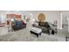 Open-concept living room with stylish furnishings, tile flooring, and seamless connection to the kitchen and dining areas at 1545 Caterpillar St, St Cloud, FL 34771