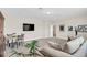 Spacious living room featuring neutral carpeting, a sectional sofa, a dining table, and a wall-mounted TV at 1545 Caterpillar St, St Cloud, FL 34771