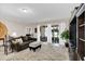 Relaxing living room with large sliding glass doors to a screened in patio and access to other rooms of the house at 1545 Caterpillar St, St Cloud, FL 34771