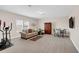 Spacious living room featuring neutral carpeting, a sofa, a dining table, and exercise equipment at 1545 Caterpillar St, St Cloud, FL 34771