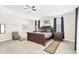 Elegant main bedroom with tray ceiling, carpet floors, and stylish furnishings at 1545 Caterpillar St, St Cloud, FL 34771