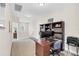 Bright office features a large desk and bookshelf, offering a practical and organized workspace at 1545 Caterpillar St, St Cloud, FL 34771