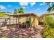 Cozy backyard featuring a covered patio with an outdoor dining set and lush landscaping at 1624 Park Lake St, Orlando, FL 32803