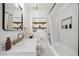 Chic bathroom featuring white subway tile, a shower with a bathtub, and a modern vanity at 1624 Park Lake St, Orlando, FL 32803