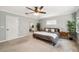 Comfortable bedroom with a view into the bathroom, neutral tones, and a ceiling fan at 1624 Park Lake St, Orlando, FL 32803
