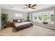 Serene bedroom featuring a large bed, bay window with seating, and calming neutral decor at 1624 Park Lake St, Orlando, FL 32803