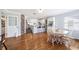 Open-concept dining room with hardwood floors, exposed brick, and an eat-in kitchen with modern appliances at 1624 Park Lake St, Orlando, FL 32803