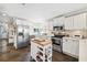 Well-equipped kitchen with stainless steel appliances, white cabinets, and a stylish island with butcher block top at 1624 Park Lake St, Orlando, FL 32803