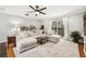 Cozy living room with a soft sectional sofa, area rug, and natural light streaming through a sliding glass door at 1624 Park Lake St, Orlando, FL 32803