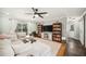 Bright living room featuring a plush sectional sofa, bookshelves, and a sliding door to the backyard at 1624 Park Lake St, Orlando, FL 32803