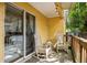 Inviting patio with wooden flooring, two rocking chairs, string lights, and sliding door into the home at 1624 Park Lake St, Orlando, FL 32803
