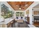 Cozy sunroom with a wooden ceiling, slate floors, large windows, and bright airy living space at 1624 Park Lake St, Orlando, FL 32803