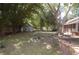 Expansive backyard featuring a storage shed, screened-in porch, and a brick feature with ample green space at 1644 Cypress Woods Cir, St Cloud, FL 34772