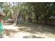 Spacious, tree-filled backyard with a small storage shed, offering plenty of room for outdoor activities at 1644 Cypress Woods Cir, St Cloud, FL 34772