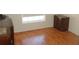 This bedroom features wooden floors, a bright window and classic furnishings at 1644 Cypress Woods Cir, St Cloud, FL 34772