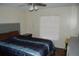 Bedroom with a large bed, fan, and window at 1644 Cypress Woods Cir, St Cloud, FL 34772