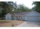 Well-lit single story home featuring mature landscaping and a two car garage at 1644 Cypress Woods Cir, St Cloud, FL 34772