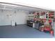 Spacious garage interior with epoxy flooring, shelving units, and ample space for parking and storage solutions at 1644 Cypress Woods Cir, St Cloud, FL 34772