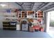 Garage featuring ample overhead lighting, custom shelving, and lots of wall storage options at 1644 Cypress Woods Cir, St Cloud, FL 34772