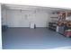 Epoxy garage flooring, ample lighting, and plenty of shelving for storage at 1644 Cypress Woods Cir, St Cloud, FL 34772