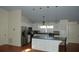 Bright kitchen featuring an island with seating, hardwood floors, and stainless steel appliances at 1644 Cypress Woods Cir, St Cloud, FL 34772
