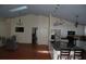 Open floor plan with kitchen island, hardwood floors, vaulted ceiling and modern appliances at 1644 Cypress Woods Cir, St Cloud, FL 34772