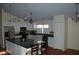 Well-lit kitchen featuring a spacious island, hardwood floors, stainless steel appliances and ample cabinet space at 1644 Cypress Woods Cir, St Cloud, FL 34772