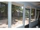 Screened porch featuring natural lighting, leading to a spacious backyard, perfect for outdoor enjoyment at 1644 Cypress Woods Cir, St Cloud, FL 34772