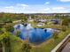 Community aerial view showcasing a scenic pond, playground, and lush landscaping at 16500 Cedar Run Dr, Orlando, FL 32828