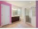Bright bathroom with double sinks, glass shower, tile flooring, and a tub at 16500 Cedar Run Dr, Orlando, FL 32828