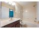 Bright bathroom features a large vanity, toilet, and a shower-over-tub setup at 16500 Cedar Run Dr, Orlando, FL 32828