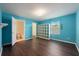 Bright bedroom has laminate flooring, blue walls, a window and ensuite bathroom at 16500 Cedar Run Dr, Orlando, FL 32828