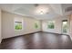 Spacious bedroom features a tray ceiling, dark wood floors and lots of natural light at 16500 Cedar Run Dr, Orlando, FL 32828