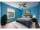 Stylish bedroom with a ceiling fan, large window, hardwood floors, and a decorative rug at 16500 Cedar Run Dr, Orlando, FL 32828