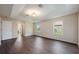 This bedroom offers a tray ceiling, dark wood floors and neutral paint at 16500 Cedar Run Dr, Orlando, FL 32828