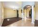 The dining room features a blend of tile and wood flooring, along with white pillars and trim at 16500 Cedar Run Dr, Orlando, FL 32828