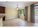 An empty, sunlit dining area with tile floors and a view of the pool at 16500 Cedar Run Dr, Orlando, FL 32828