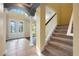 Bright foyer features decorative glass doors, tile flooring, columns, and staircase leading upstairs at 16500 Cedar Run Dr, Orlando, FL 32828
