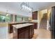Bright kitchen featuring stainless steel appliances, granite countertops, and stairs to second floor at 16500 Cedar Run Dr, Orlando, FL 32828