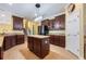 Stylish kitchen with dark wood cabinets, granite countertops, and a functional center island at 16500 Cedar Run Dr, Orlando, FL 32828