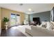 Comfortable living room with hardwood floors, neutral colors, and French doors leading to outdoor space at 16500 Cedar Run Dr, Orlando, FL 32828