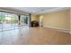 Open-concept living room with tile flooring and access to the pool area with large glass doors at 16500 Cedar Run Dr, Orlando, FL 32828