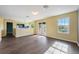An empty living room featuring wood-look floors, natural lighting, and neutral-colored walls at 16500 Cedar Run Dr, Orlando, FL 32828