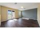 An empty living room featuring wood-look floors, neutral-colored walls, and bright, natural lighting at 16500 Cedar Run Dr, Orlando, FL 32828