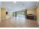 Open-concept living room with tile flooring and access to the outdoor pool area at 16500 Cedar Run Dr, Orlando, FL 32828