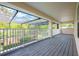 Large, screened patio overlooking manicured backyard with fence; perfect for outdoor entertaining at 16500 Cedar Run Dr, Orlando, FL 32828