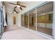 Enclosed patio featuring ceiling fans and large sliding glass doors overlooking the pool at 16500 Cedar Run Dr, Orlando, FL 32828